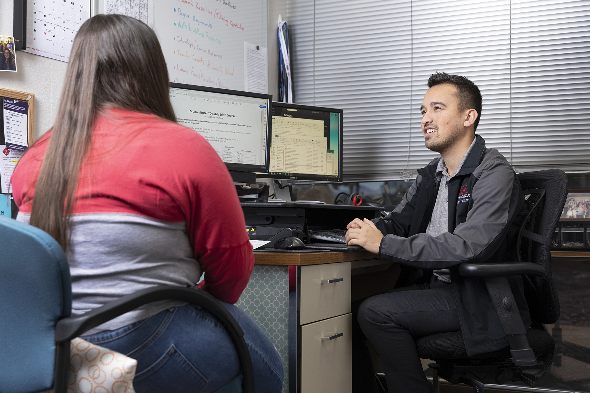 A student speaking with her advisor