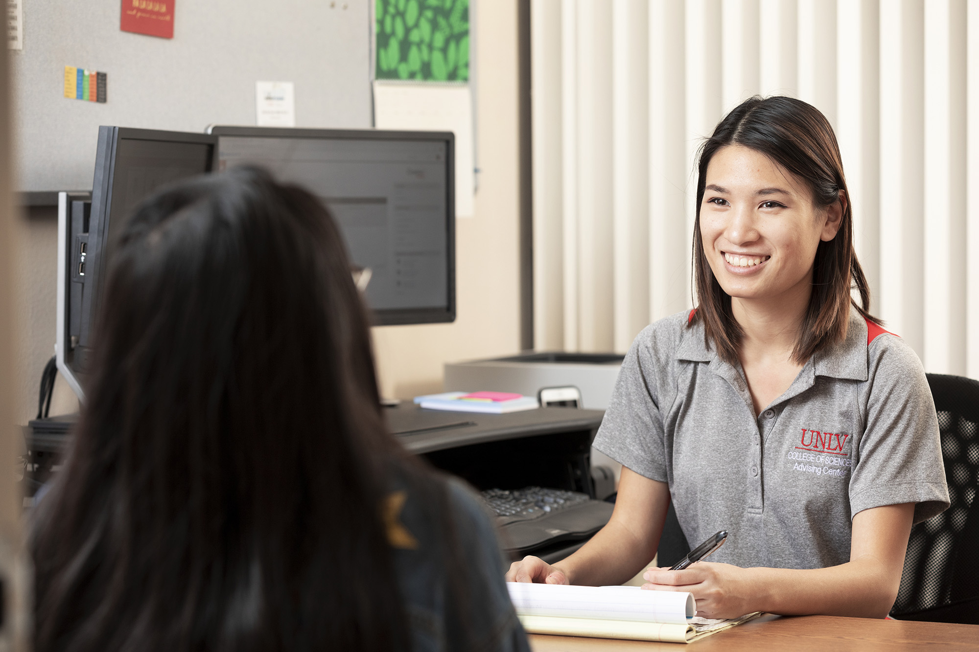 A student speaking with her advisor