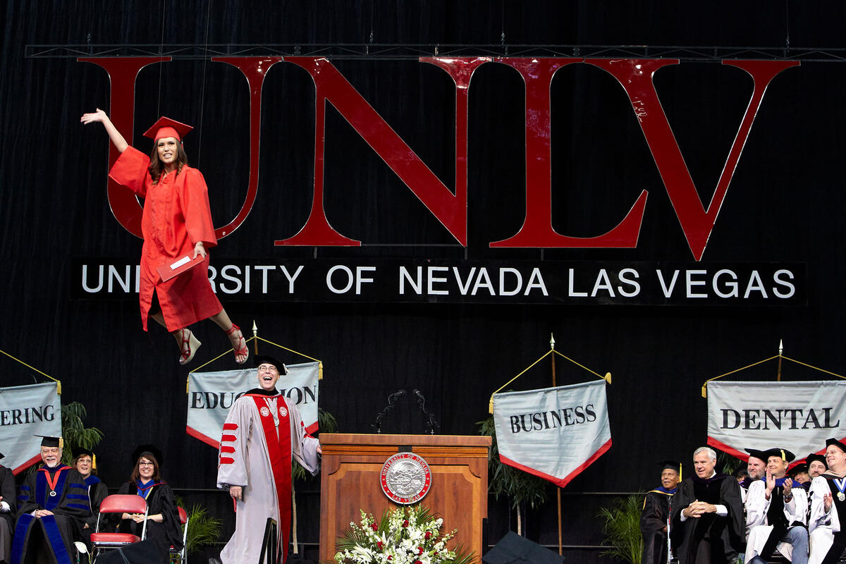 Woman walking across Commencement stage