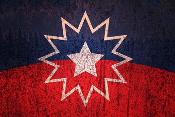 The Juneteenth flag, concentric white stars on a field of red and blue