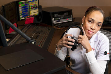 Vanessa McConnell sitting in a radio control booth