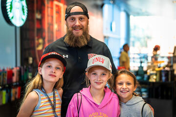 man and three daughters wearing UNLV hats