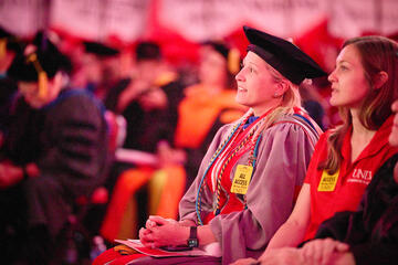 Valarie Burke sits in regalia during ceremony