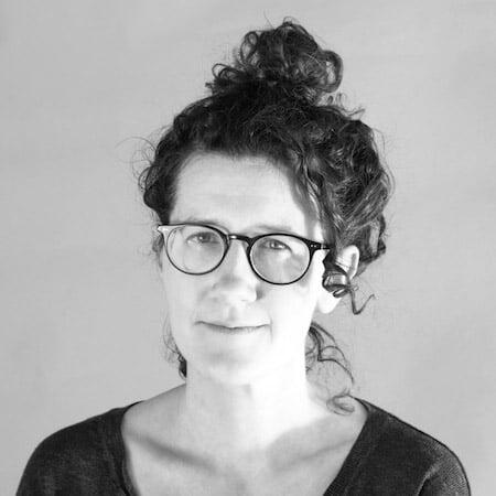 A smiling woman with glasses.