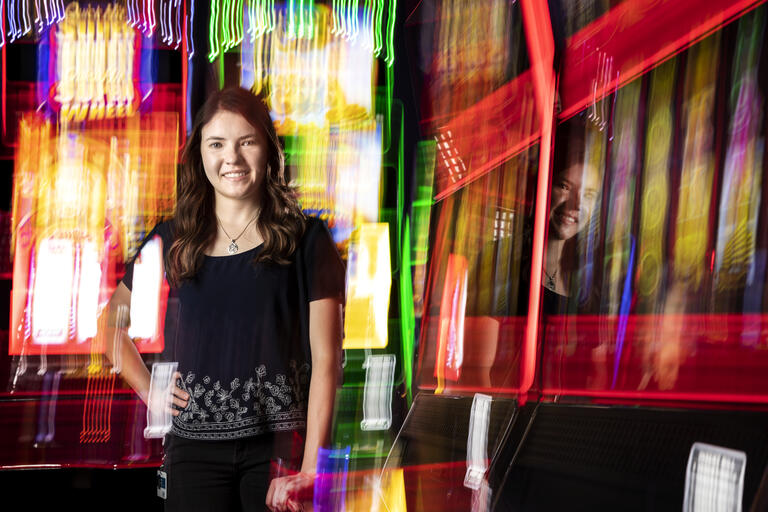 woman surrounded by video slot machines